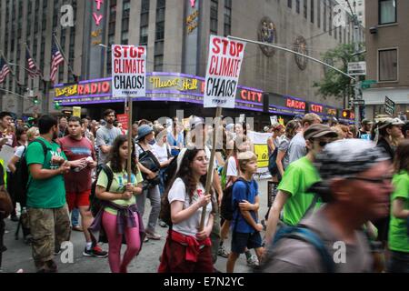 New York, USA. 21st September, 2014.  People walk down the 6th Avenue as they partcipate in the People's Climate March in Manhattan, New York, the United States on Sept. 21, 2014. Hundreds of thousands of people took part in the march here on Sunday, calling for more attention to and more action on the issue of climate change. Credit:  Niu Xiaolei/Xinhua/Alamy Live News Stock Photo