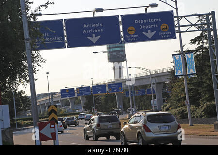 Vancouver, BC Canada - August 17,  2014 : Arrivals and departures road sign in YVR airport in Vancouver BC Canada. Stock Photo