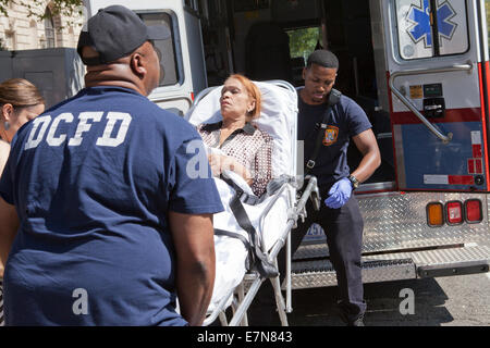 DCFD EMT loading patient into ambulance - Washington, DC USA Stock Photo