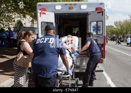 DCFD EMT loading patient into ambulance - Washington, DC USA Stock Photo