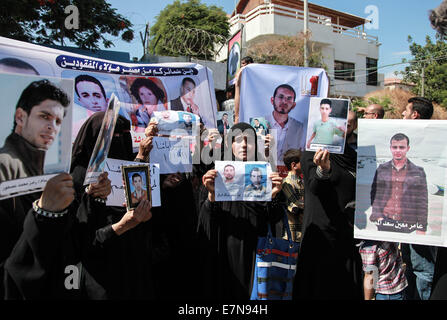 Gaza, Egypt. 21st Sep, 2014. Relatives of Palestinian immigrants who drowned at sea off the coast of Alexandria, Egypt, take part in a protest calling for the disclosure of the fate of their relatives, in front of the Red Cross office in Gaza City on Sept 21, 2014. It was reported that two ships (one off the coast of Malta and the other off the coast of Egypt) carrying Palestinians from Gaza sank, resulting in hundreds of passengers drowning. © Wissam Nassar/Xinhua/Alamy Live News Stock Photo