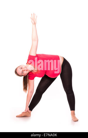 Pregnant woman doing gymnastic exercises isolated over white background, active and sportive pregnancy, healthy motherhood conce Stock Photo