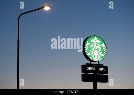 A Starbucks coffee drive through sign logo.
