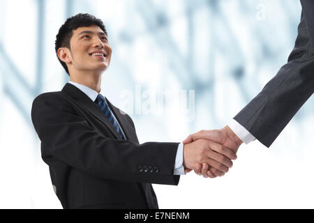Businesspeople shaking hands at meeting Stock Photo
