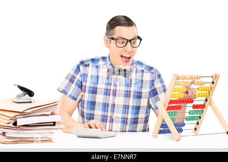 Man calculating on an abacus seated at a table isolated on white background Stock Photo