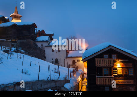 Grimentz, Switzerland, Europe, canton Valais, Val d'Anniviers, village, houses, homes, church, dusk, lighting, illumination, win Stock Photo