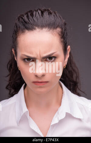 Serious woman wearing white blouse Stock Photo