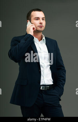 Portrait of pensive businessman talking on the phone Stock Photo
