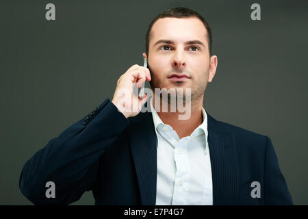 Portrait of a thoughtful businessman talking on the phone Stock Photo