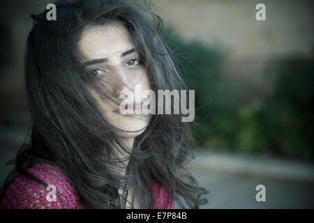 Young woman hair covering face outdoors Stock Photo