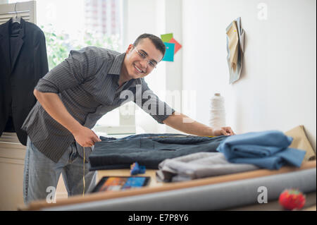 Fashion designer measuring vest Stock Photo