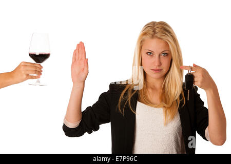 beautiful blond woman gesturing don't drink and drive gesture, with refusing a glass of red wine isolated over white Stock Photo
