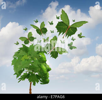 Creative communication and intelligent marketing concept as a tree shaped as a human head with flying leaves turning into magical leaf butterflies spreading the message and sharing the innovative thoughts and imagination.
