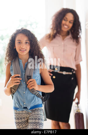 Daughter (8-9) and mother going to school Stock Photo