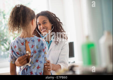 Female doctor examining girl (8-9) Stock Photo