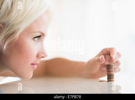 Close-up of woman stacking coins Stock Photo