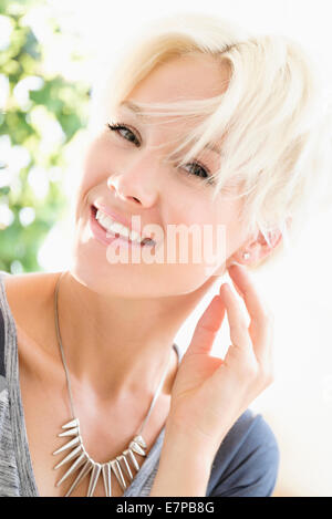 Portrait of blonde woman wearing necklace Stock Photo