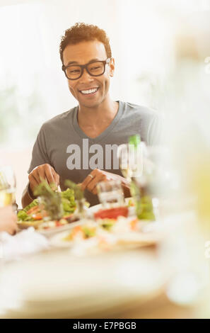 Young man enjoying dinner party Stock Photo