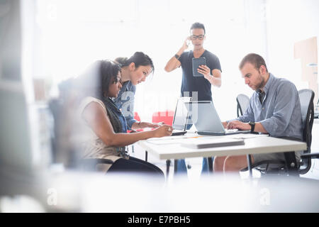 Women and men working in office Stock Photo