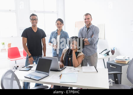 Women and men working in office Stock Photo