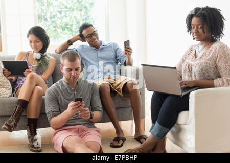 Friends hanging out in living room Stock Photo