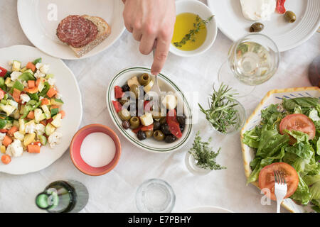 Hand serving salad Stock Photo