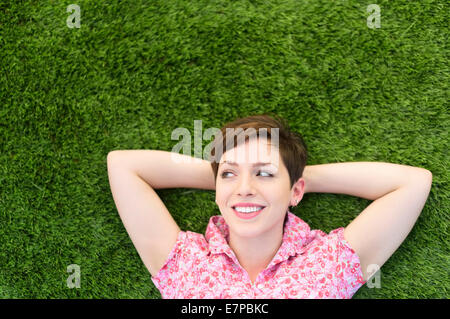 Young woman lying on grass Stock Photo