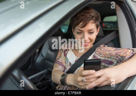 Female driver text messaging Stock Photo - Alamy
