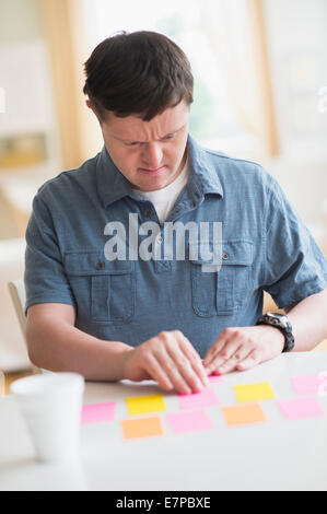 Man with down syndrome playing memory game Stock Photo