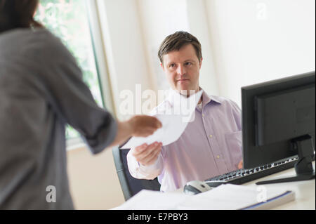 Man with down syndrome working in office Stock Photo