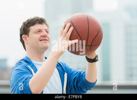 Man with down syndrome playing basketball Stock Photo