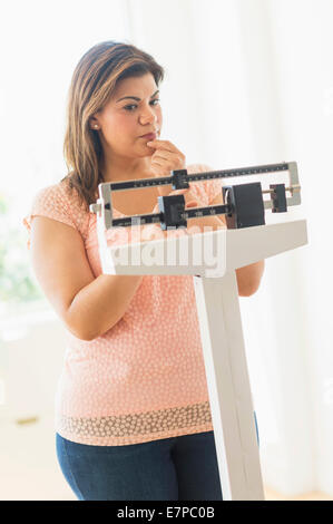 Woman standing on scale Stock Photo