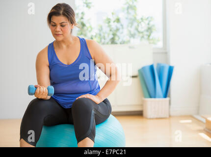 Woman exercising at gym Stock Photo