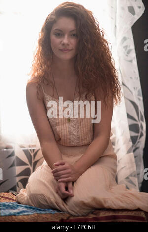 Portrait of stylish woman in window sill Stock Photo