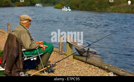 Old man fishing in the Norfolk Broads Stock Photo