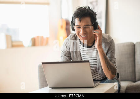 Man mixing music on laptop Stock Photo