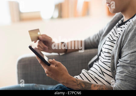 Man paying with credit card on tablet Stock Photo