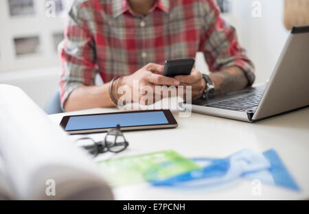 Mid section of man text messaging Stock Photo
