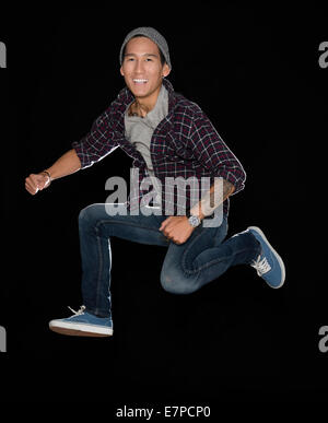 Studio shot of man jumping Stock Photo