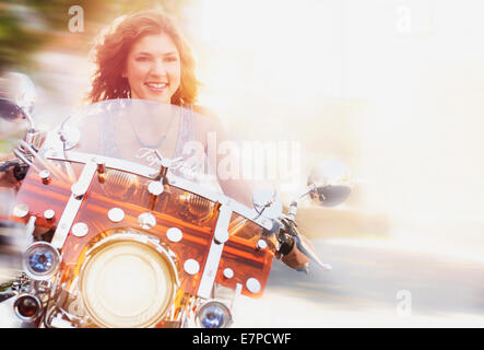 Young woman riding motorcycle Stock Photo