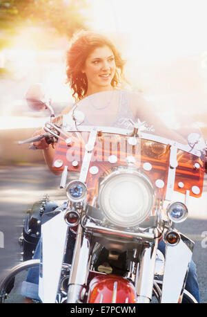Young woman riding motorcycle Stock Photo