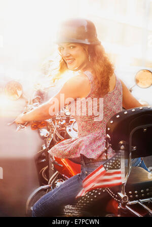 Young woman riding motorcycle Stock Photo