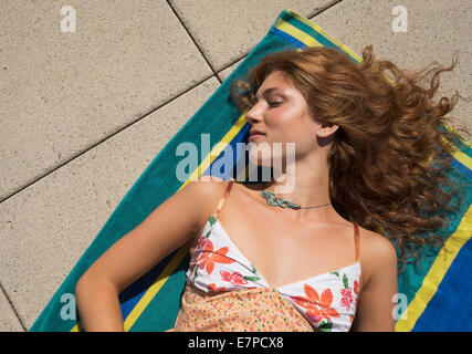 Young woman sunbathing Stock Photo