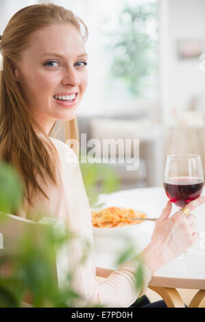 Woman having meal with red wine Stock Photo