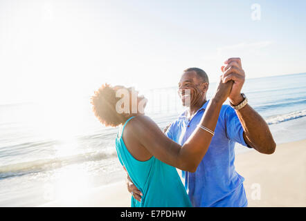 Mature couple dancing on beach Stock Photo