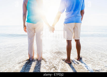 Mature couple standing in sea Stock Photo