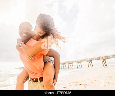 USA, Florida, Jupiter, Young couple playing on beach Stock Photo