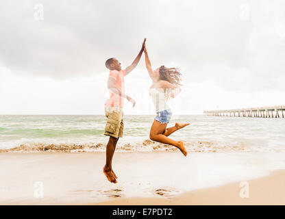 USA, Florida, Jupiter, Young couple playing on beach Stock Photo