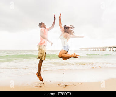 USA, Florida, Jupiter, Young couple playing on beach Stock Photo