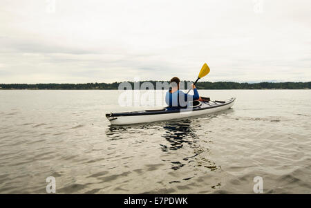 USA, Washington State, Olympia, Man kayaking on lake Stock Photo